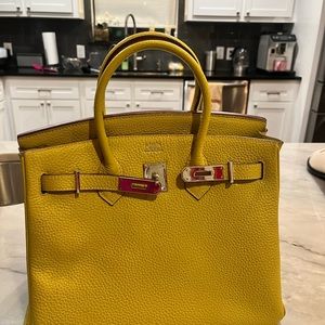 Yellow real leather purse. Paid over 500$ for it. 11.5 by 9.5 inches. Dustbag.